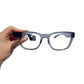 Transparent grey frames attached to the Envision Glasses - Hand holding the frames