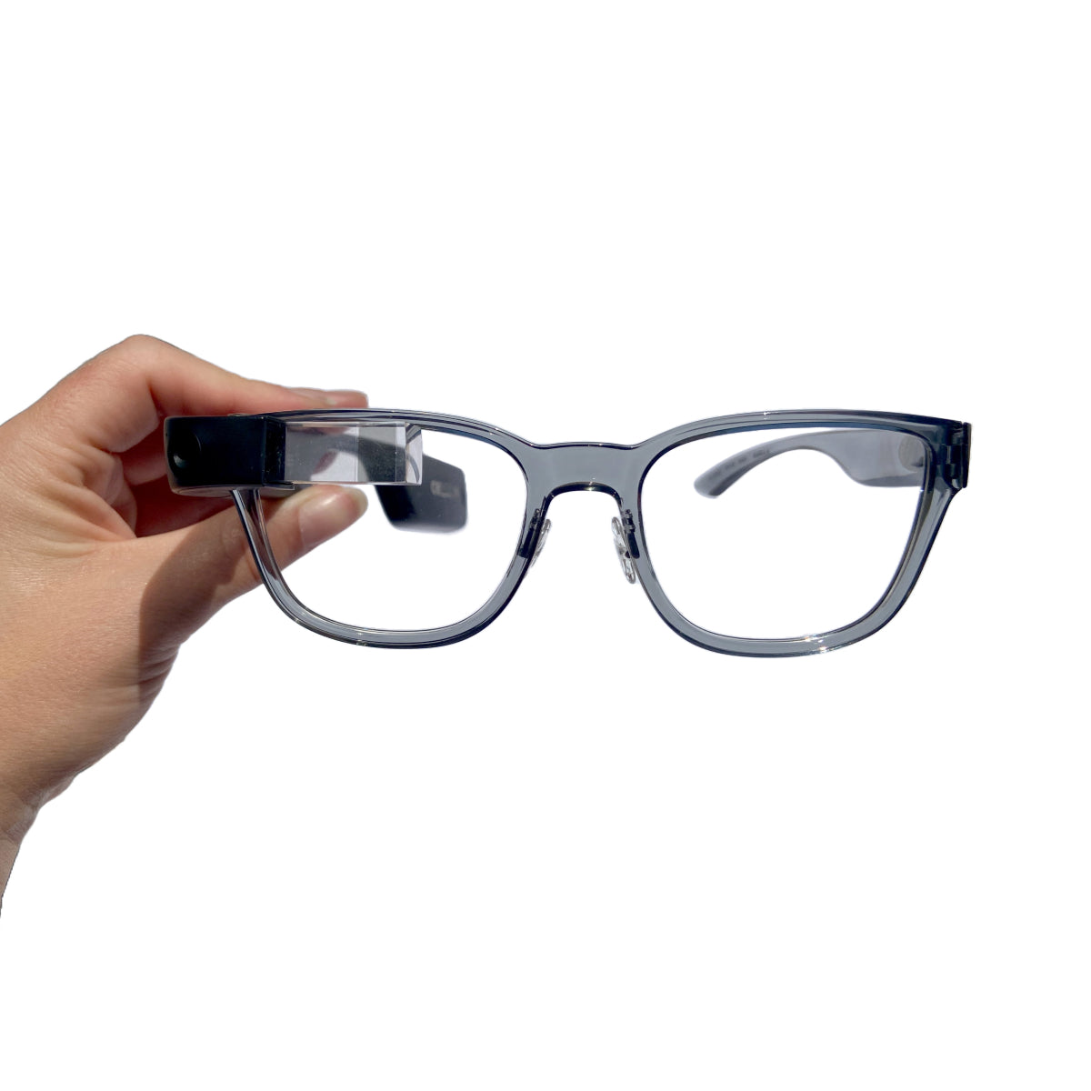 Transparent grey frames attached to the Envision Glasses - Hand holding the frames