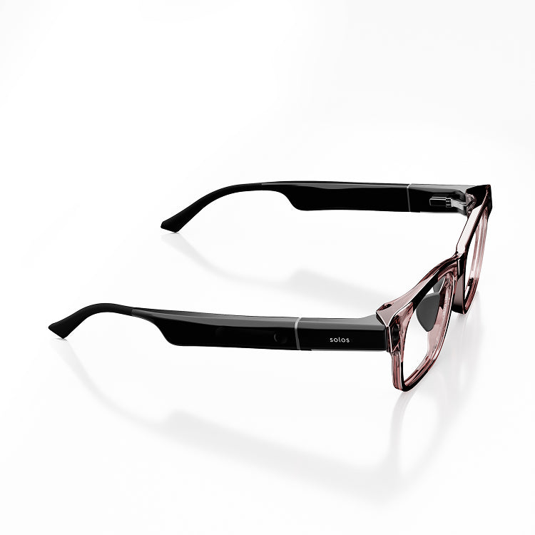 Black smartglasses with a brown transparent frame front from the side on a white background. On the side it reads 'Solos'.